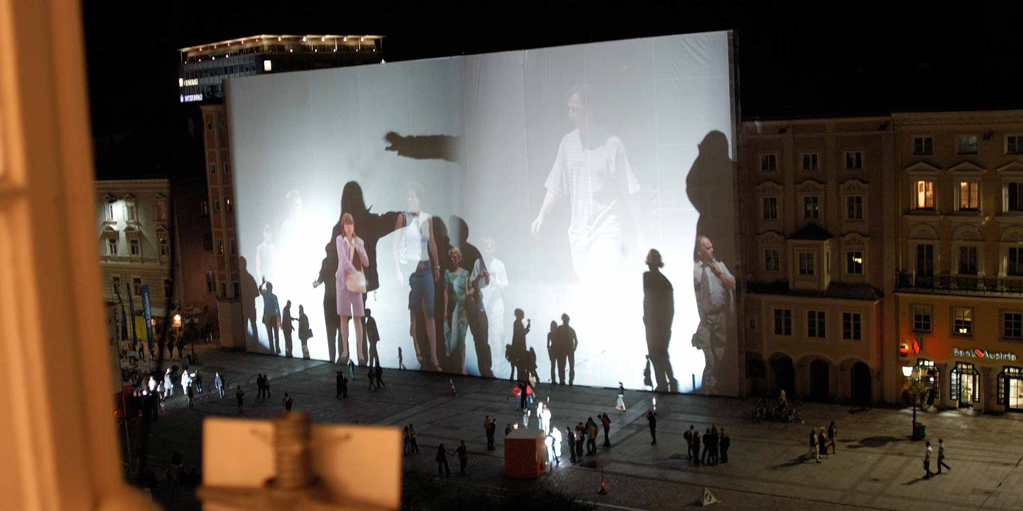 <strong>2002:</strong> "Body Movies" projects huge silhouettes and portraits onto a screen the size of a house.