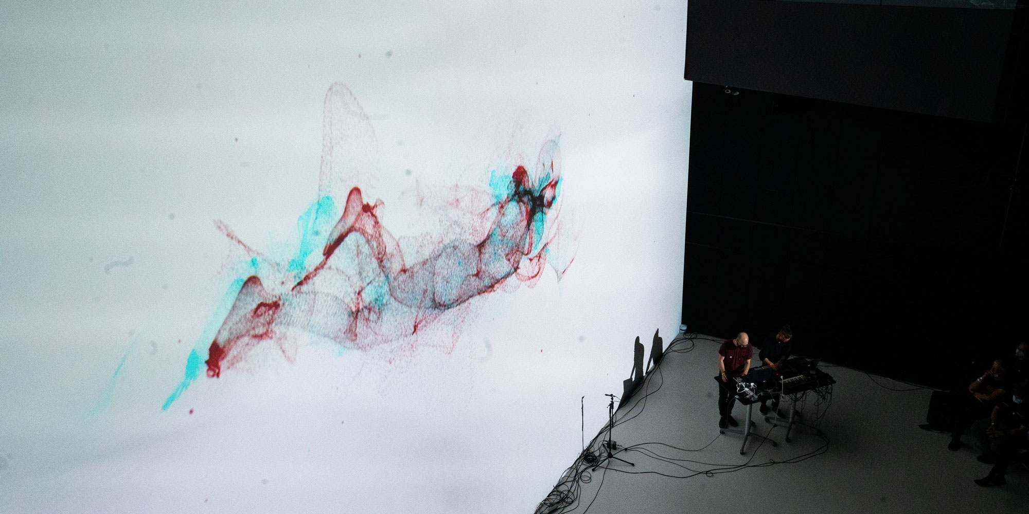 The audiovisual performance [ˈdaːzaɪn] by the artist duo Sective is an abstract narrative of a disembodied figure in virtual space and its return to the natural state of physical reality