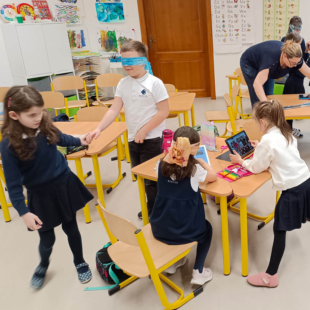 children - some blindfolded - in a classroom