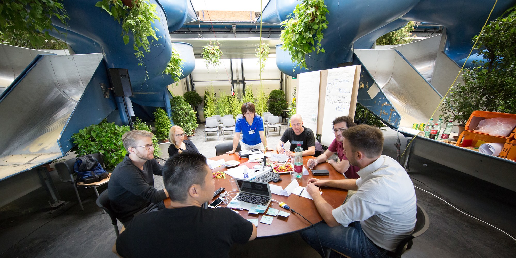 Photo showing some members of the Future Innovators Summit seated around big round table.